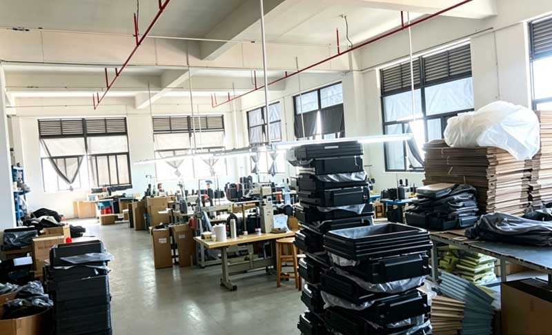 Finished ABS carry‑on luggage products in suitcase assembly factory workshop