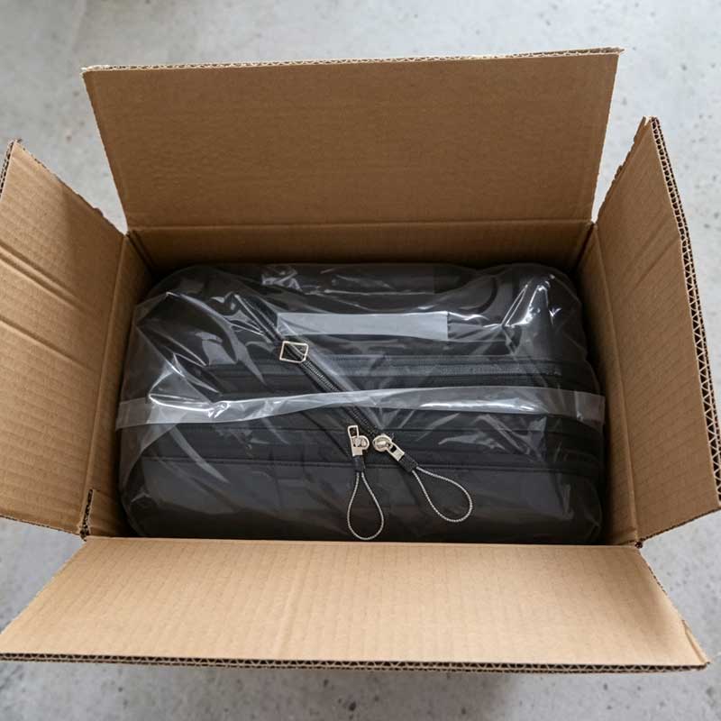 Black carry‑on luggage packed in export carton box for wholesale shipment
